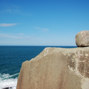 Random big round boulder perched precariously on an outcrop by the sea in Florianopolis, Brazil