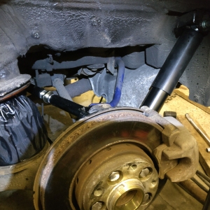 Rear near-side shock and spring fitted with protective gaitor over the spring.